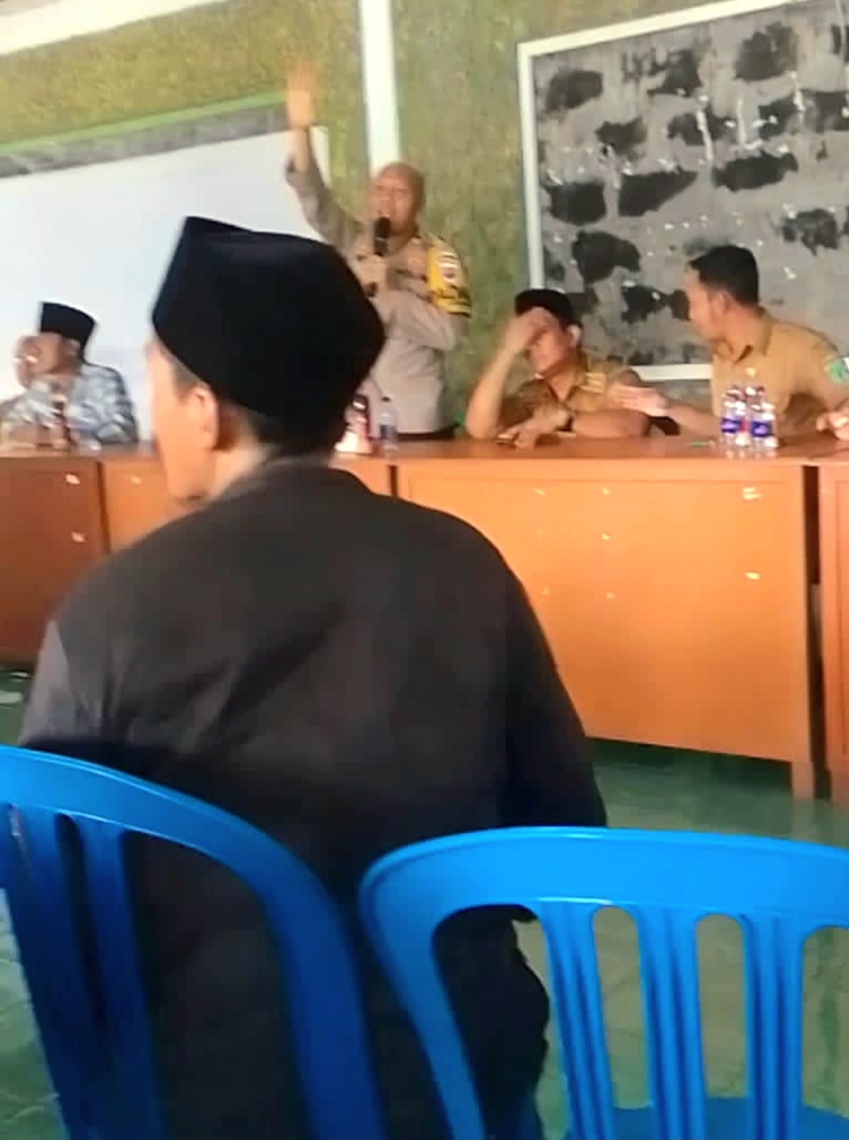 Camat Pasrepan terpancing emosi ketika debat dengan warga, dan Kapolsek berusaha menenangkan warga (Dok. Harianjatim.id)